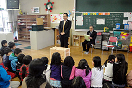 子どもらに贈呈品を紹介する神修一・農林中央金庫福岡支店長